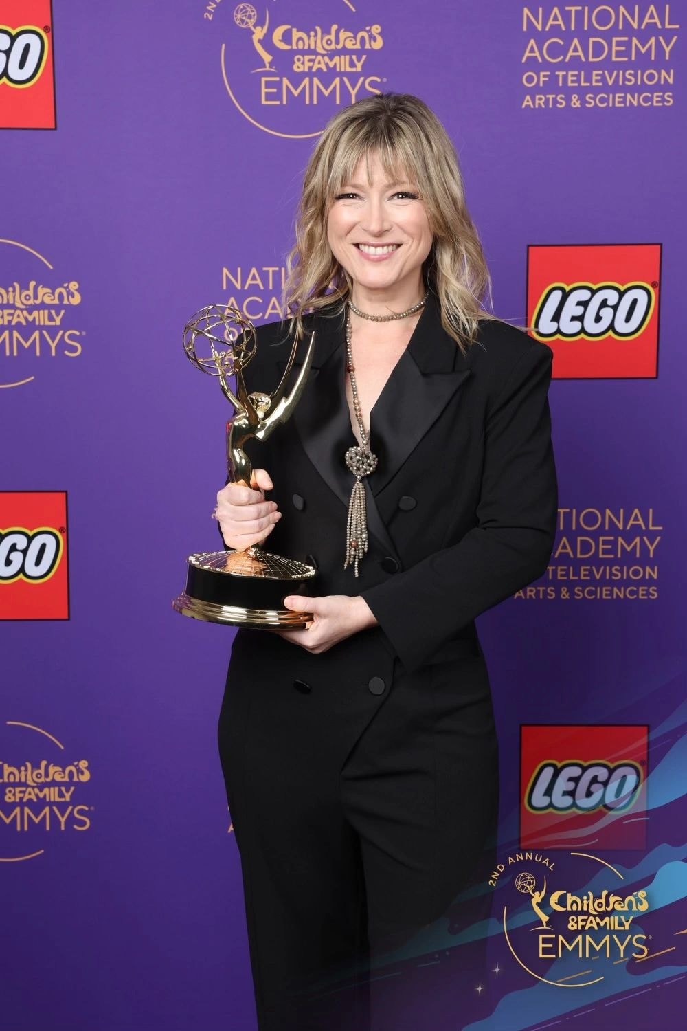 Heather Laura Gray accepting Emmy Award on stage